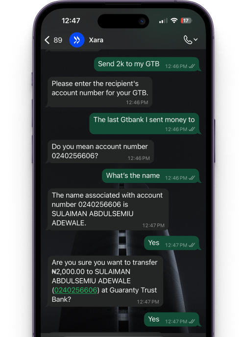 Image of a user using a phone to transfer money using Xara whatapp chat