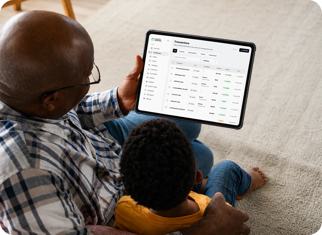 A business owner reviewing Xara dashboard transactions with a child