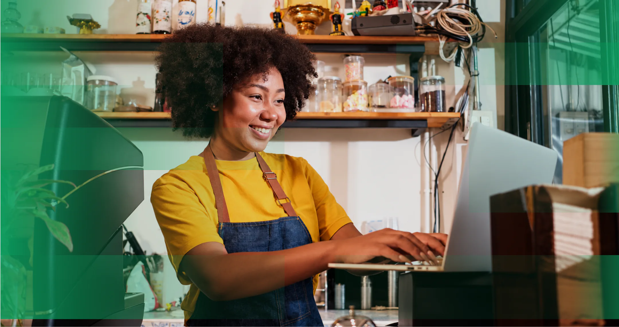 A shop owner using her computer at the counter