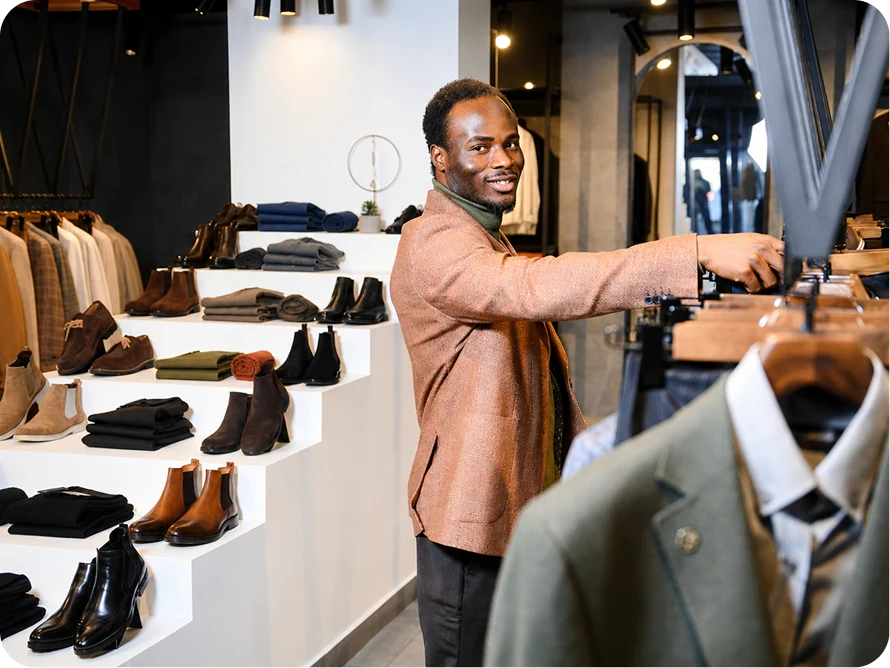 A merchant arranging products in a retail store